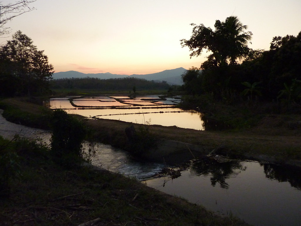 Sunset from the Inthanon Highland Resort looking west over wet rice paddies with the mountains near Doi Inthanon in the background.