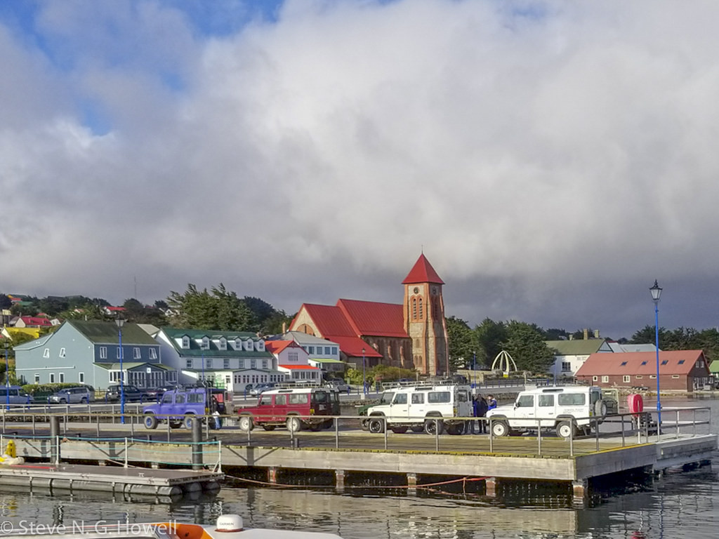 The colorful waterfront (and famous whale-bone arch) of Port Stanley herald our arrival to the remote Falkland Islands….
